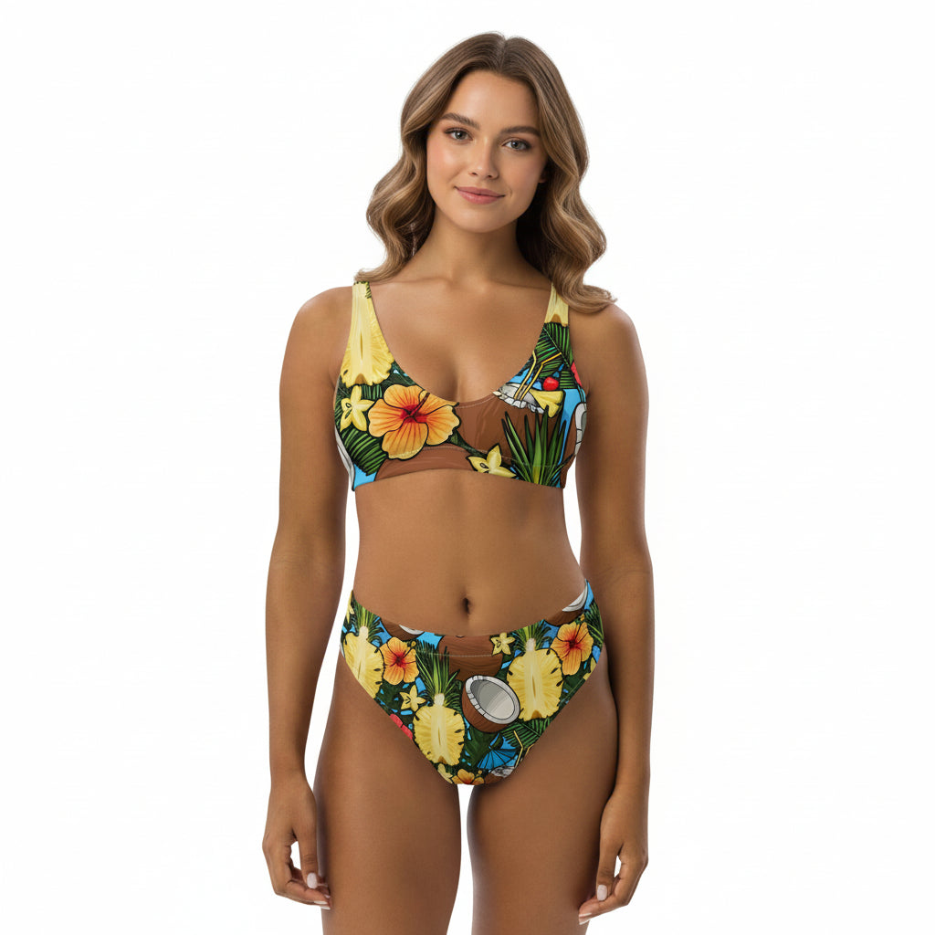 Woman wearing high-waisted bikini with tropical pineapple, coconut, and hibiscus print.