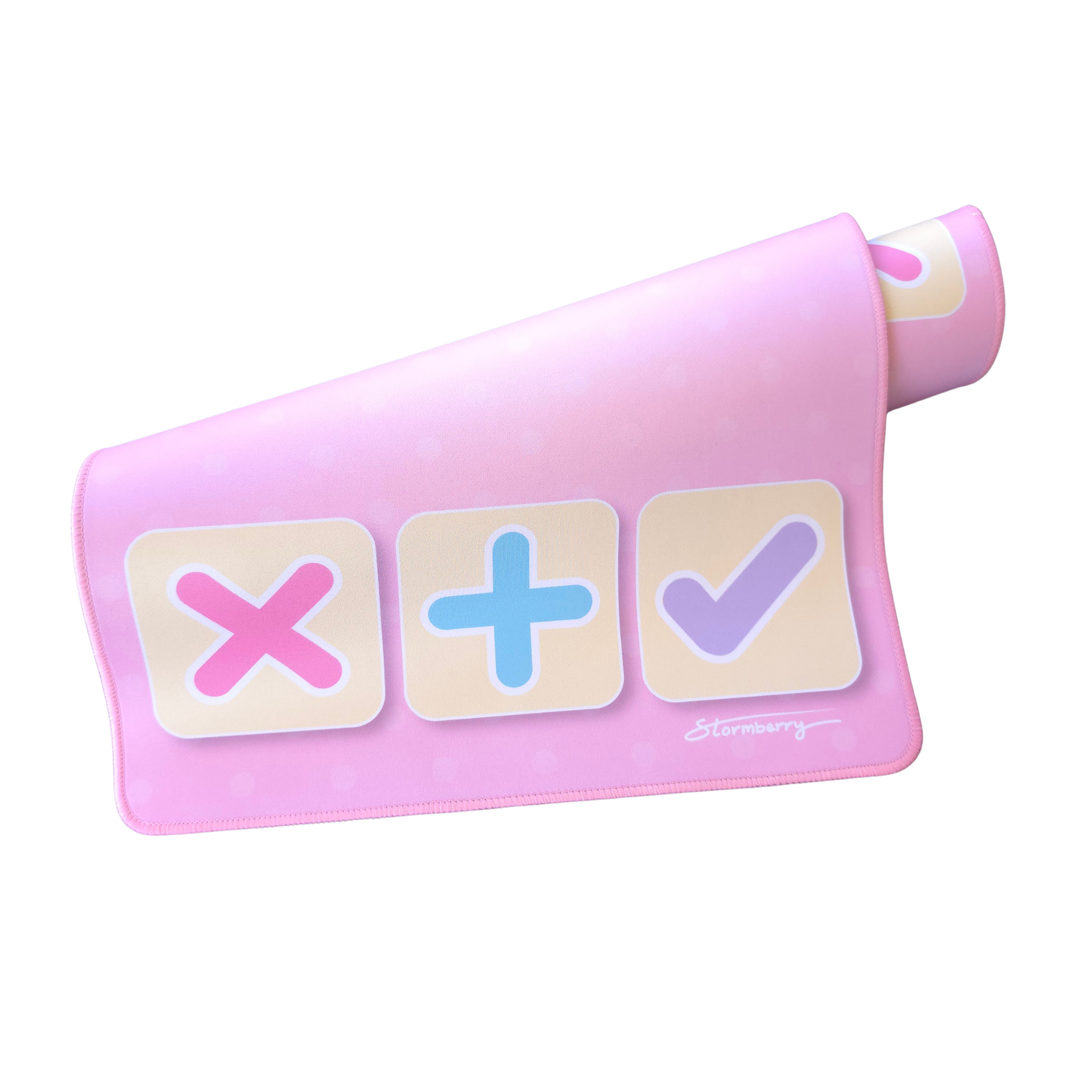 Signature Pink XL trade mat rolled up, showing the pink X, plus and lavender check tiles