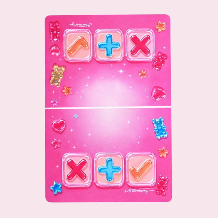 Original 12 x 18 inch Gummy Gloss trading mat laid flat, with candy artwork, pink X, blue plus and orange check symbols and smooth cut edges.