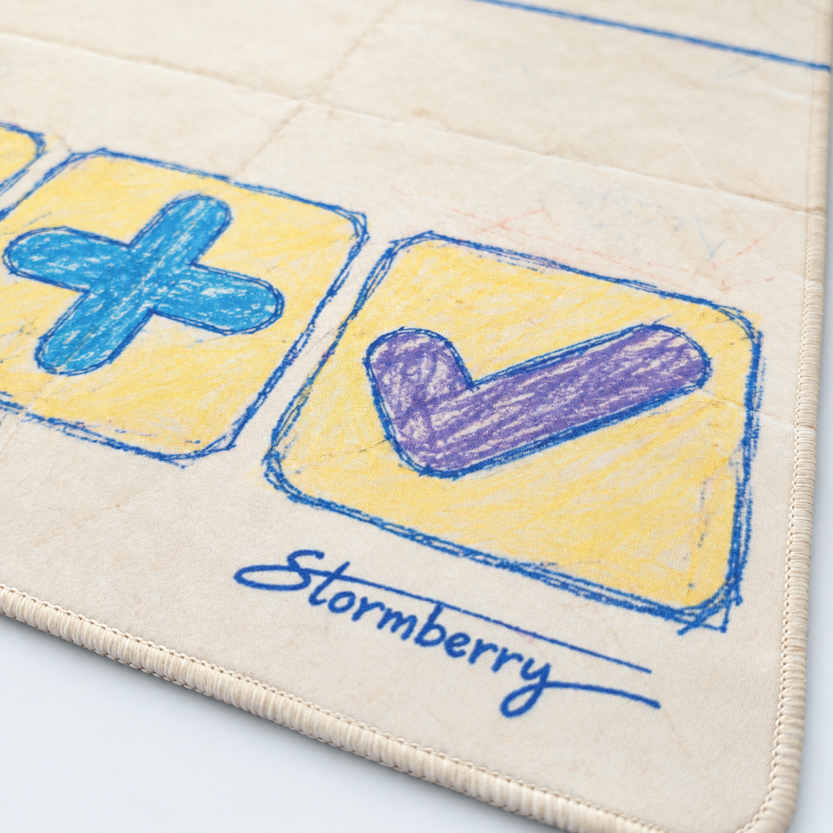 Close-up of Paper Crayon's purple check, blue plus, cream stitching and blue Stormberry signature.