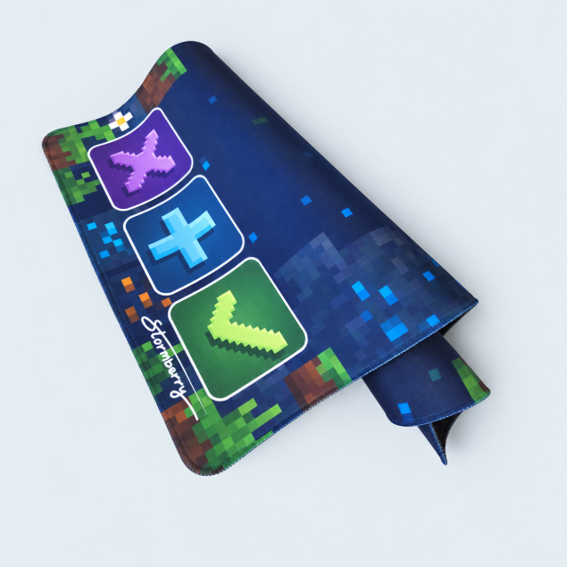 Pixel Block trading mat folded to show navy pixel artwork with a green check, blue plus and purple X.