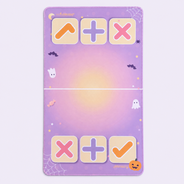 Pastel Halloween trading mat laid flat, with lavender and pink artwork, ghosts, bats, a pumpkin and a warm center glow.
