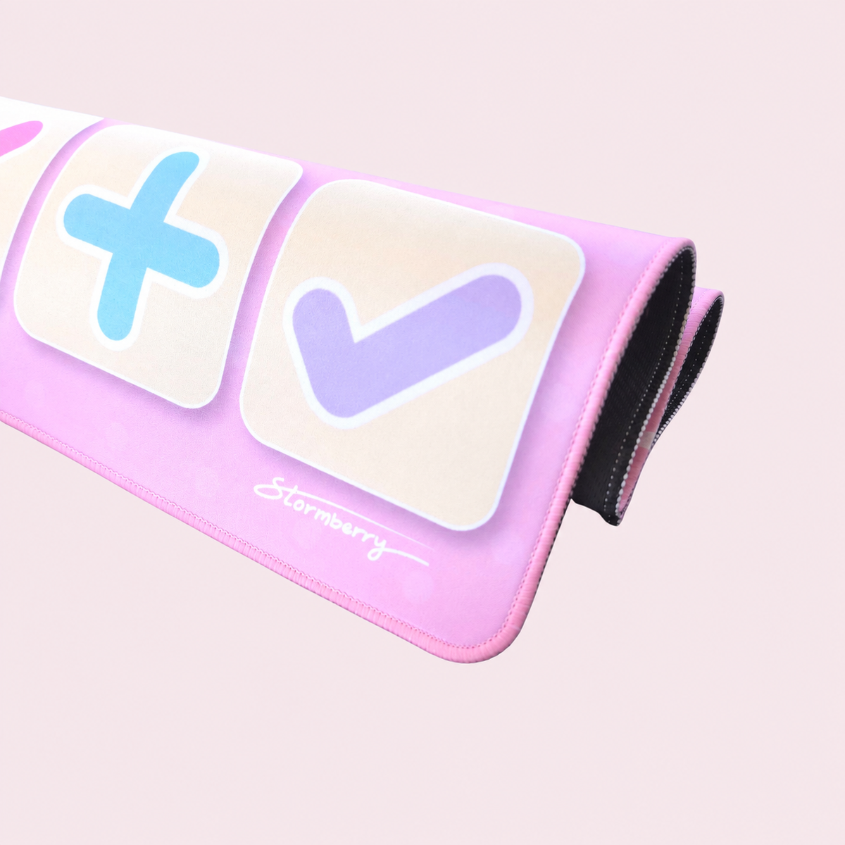 Close view of the rolled XL Pretty Pink trading mat showing the blue plus, lavender check and stitched edge.