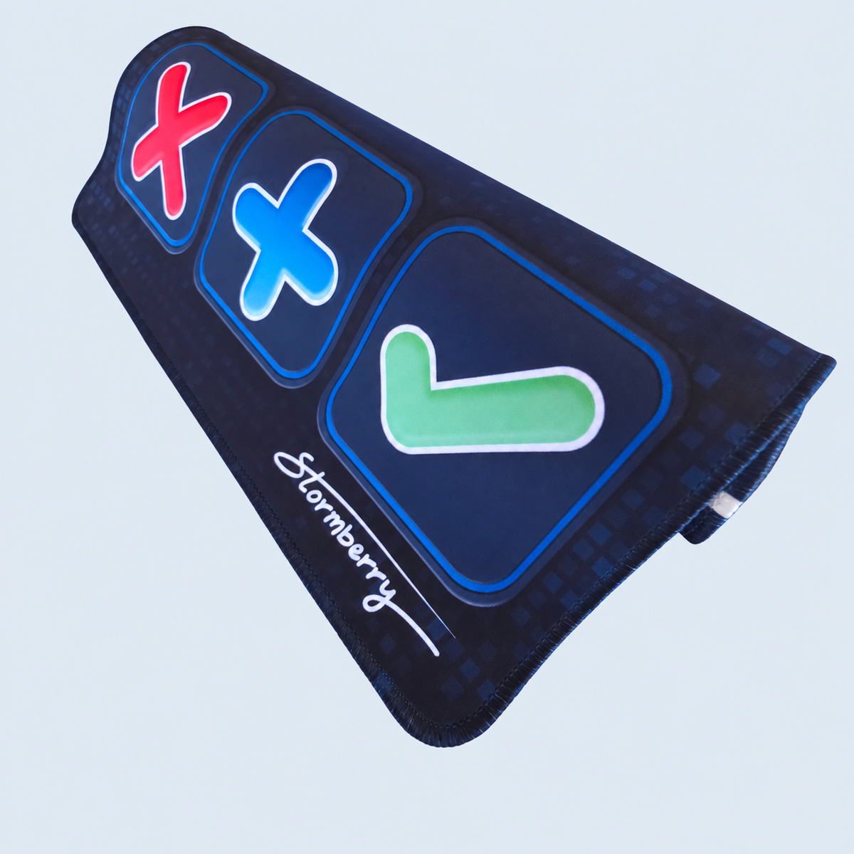 XL Blue Digital Pixel trading mat folded diagonally, with its printed trading symbols and Stormberry signature visible.